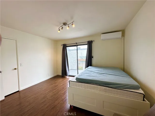 a bedroom with bed and window