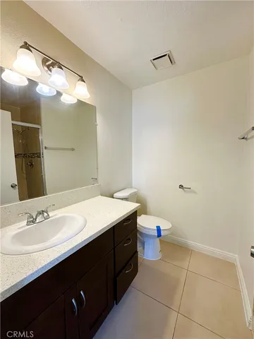 a bathroom with a sink vanity and a mirror