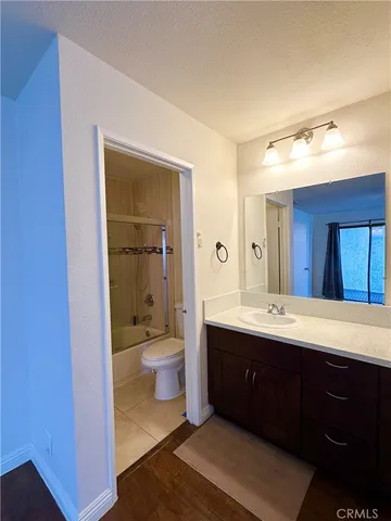 a spacious bathroom with a toilet sink and mirror