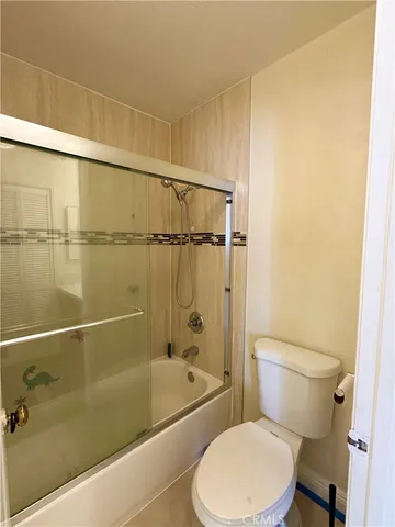 a white toilet and tub sitting next to a bathroom sink
