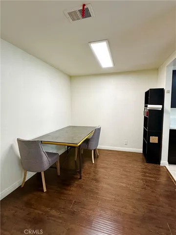 a view of a room with furniture and wooden floor
