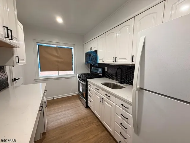 a kitchen with a sink stove and refrigerator