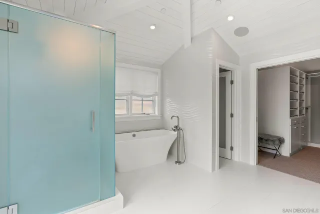 a bathroom with a tub and a shower