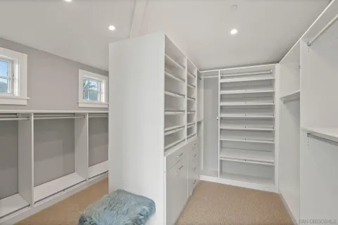 a view of walk in closet with empty racks