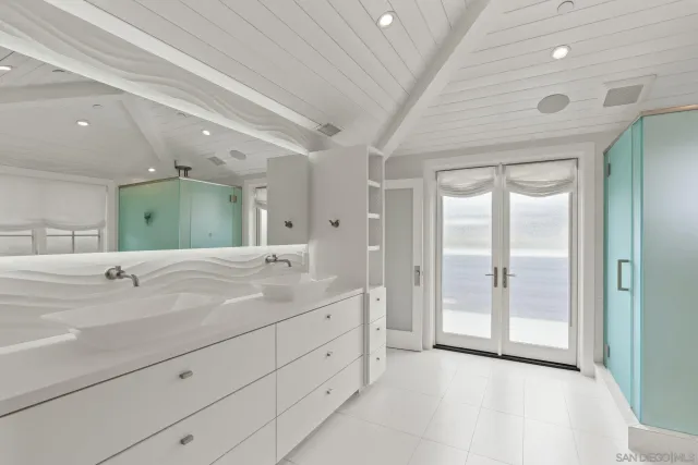 a spacious bathroom with a granite countertop sink mirror and double