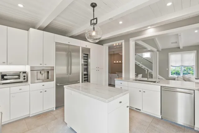 a kitchen with white cabinets sink and stainless steel appliances