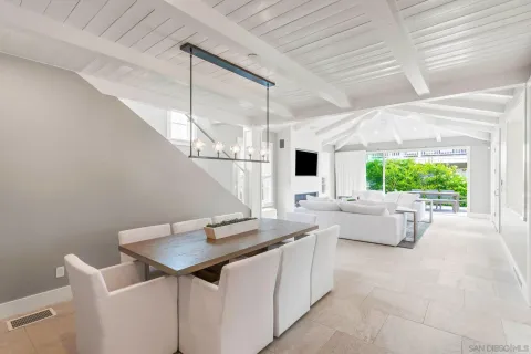a kitchen with a table chairs and a window