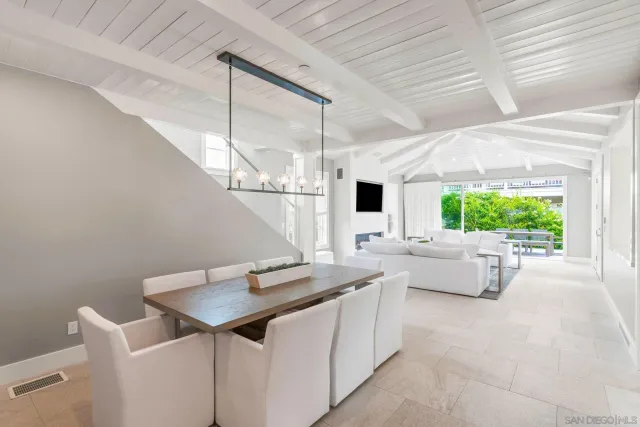 a kitchen with a table chairs and a window