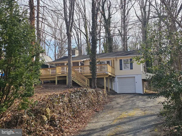 a house that has a tree in front of it