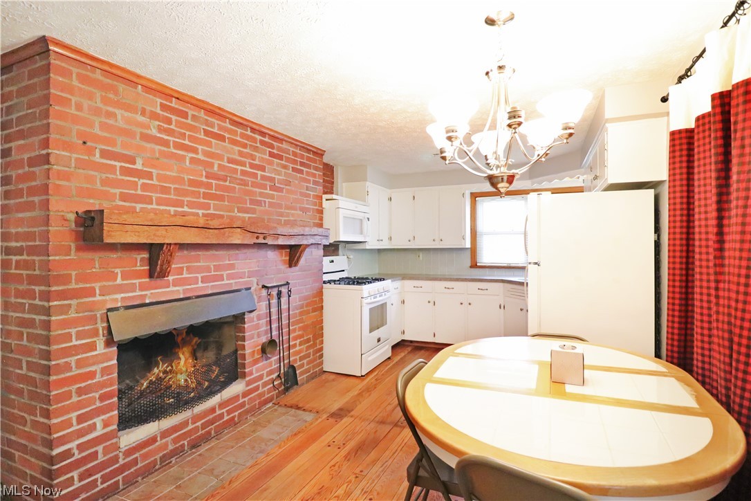 145 Waterloo Road Mogadore, OH 44260 - Photo 8 of 17 Eat in kitchen featuring double sided brick fireplace