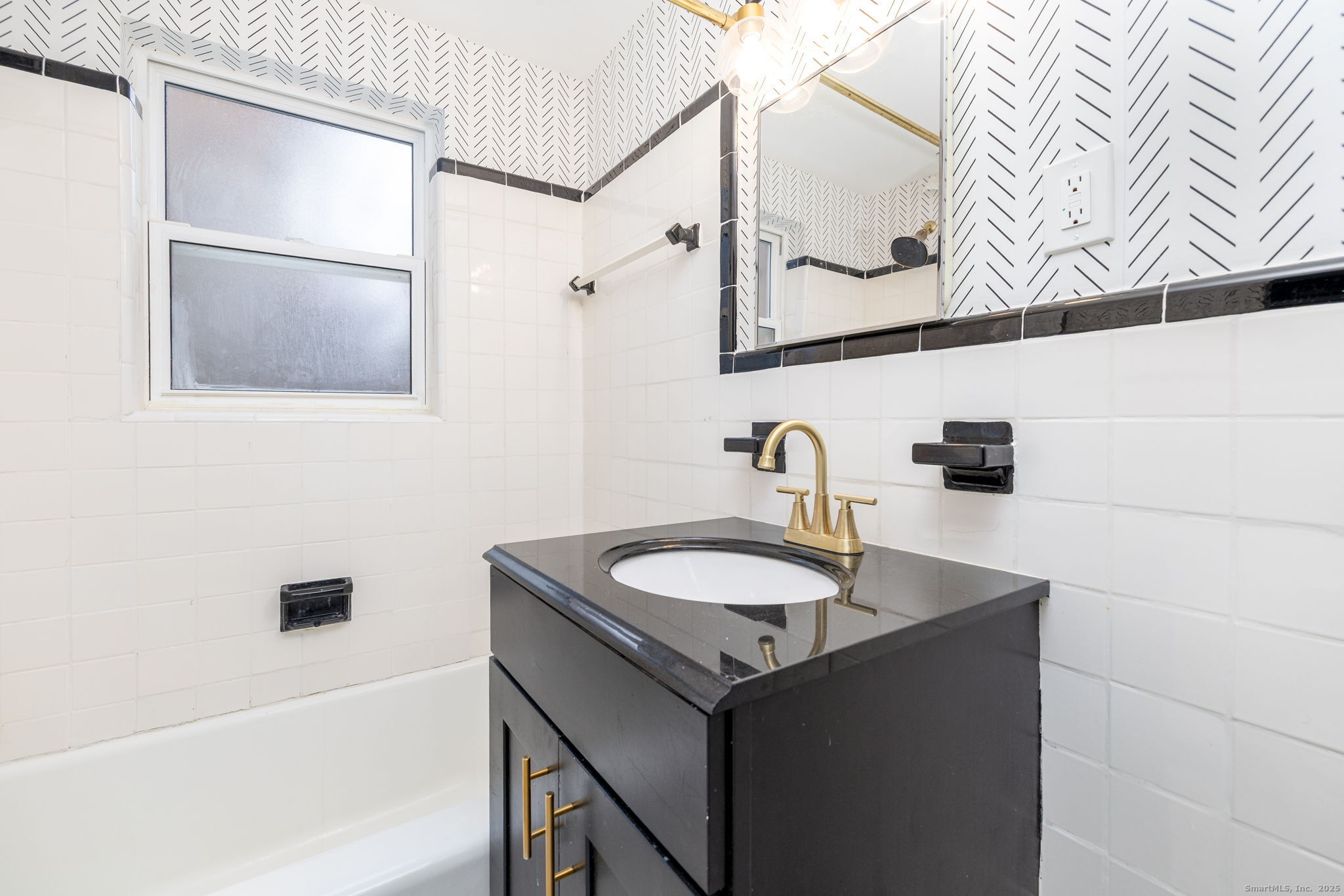 43 Arnold Way, Unit 43 West Hartford, CT 06119 - Photo 12 of 21 a bathroom with a sink and a mirror