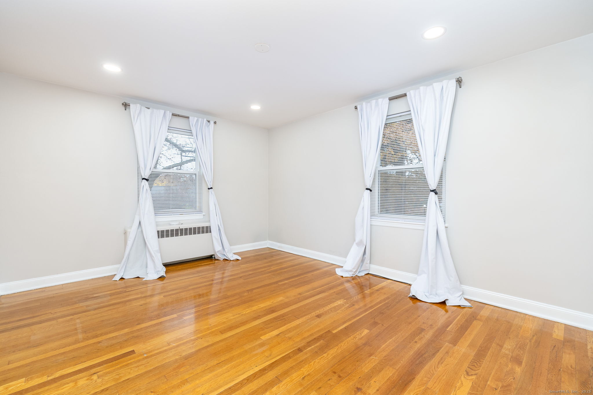 43 Arnold Way, Unit 43 West Hartford, CT 06119 - Photo 13 of 21 a view of empty room with wooden floor