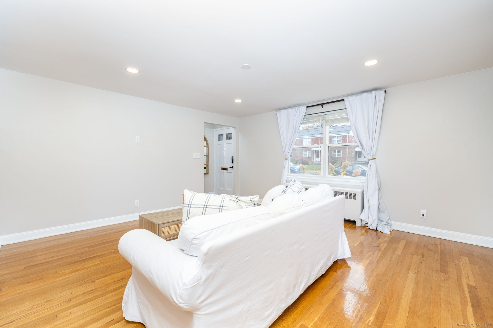 43 Arnold Way, Unit 43 West Hartford, CT 06119 - Photo 2 of 21 a living room with a bed furniture and a large window