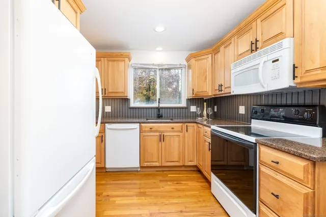 a kitchen with stainless steel appliances granite countertop a sink and a stove