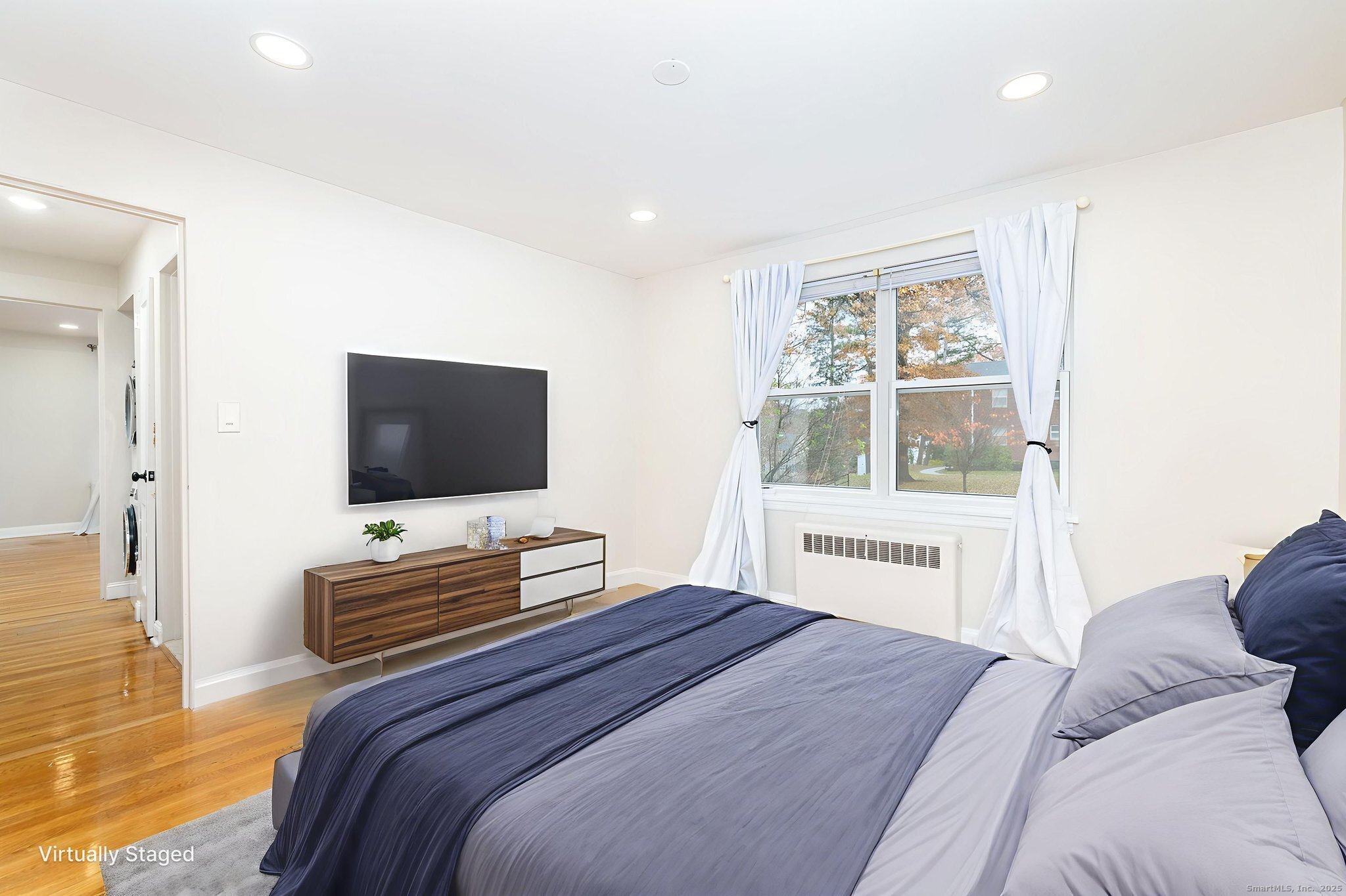 43 Arnold Way, Unit 43 West Hartford, CT 06119 - Photo 9 of 21 a bedroom with a bed and a flat screen tv