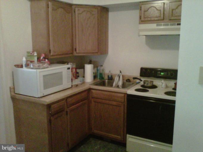 304 South Buchannan Street, Unit A B Ranson, WV 25438 - Photo 3 of 9 a kitchen with a sink and cabinets
