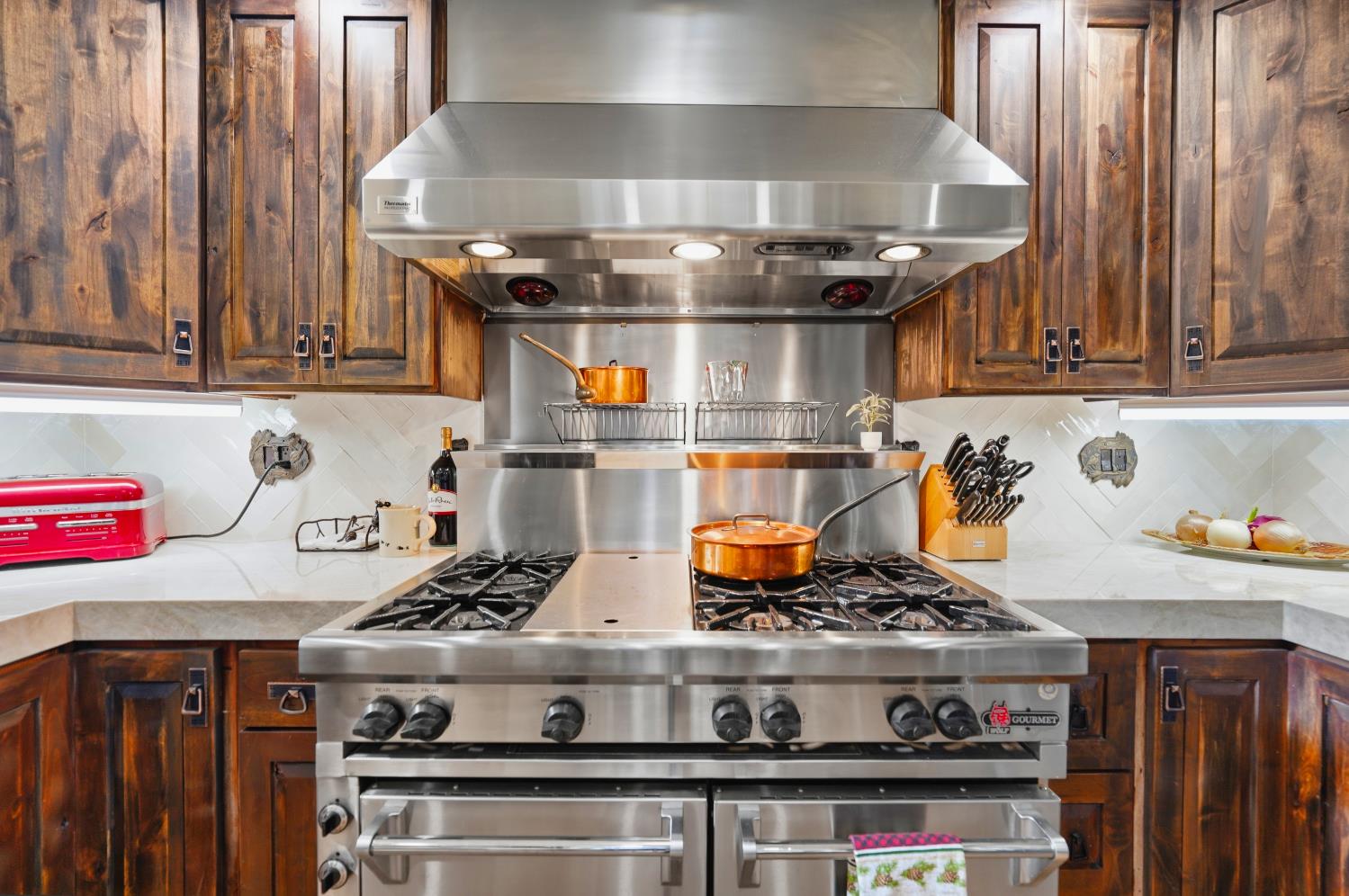 39000 Kearsarge Mill Road Alta, CA 95715 - Photo 16 of 65 a kitchen with a stove and cabinets