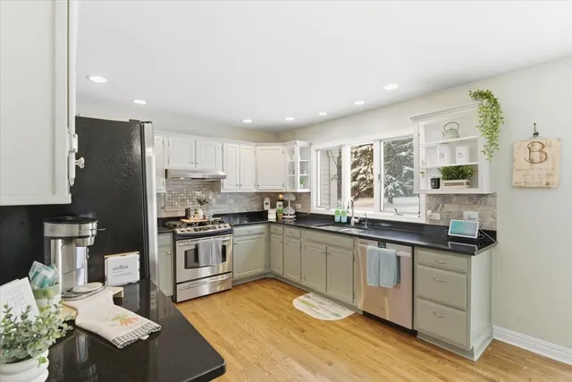 a kitchen with a sink a refrigerator and window