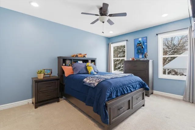 a bedroom with a large bed and a chandelier