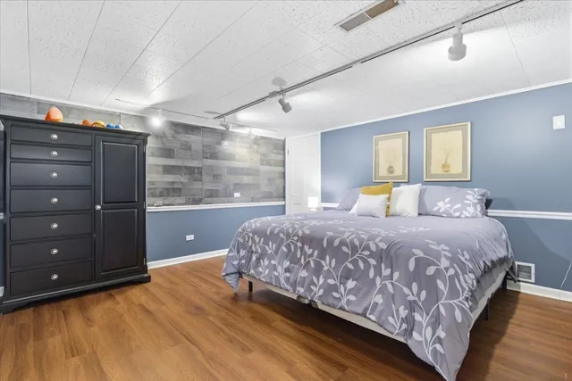 a living room with furniture and a dining table with wooden floor