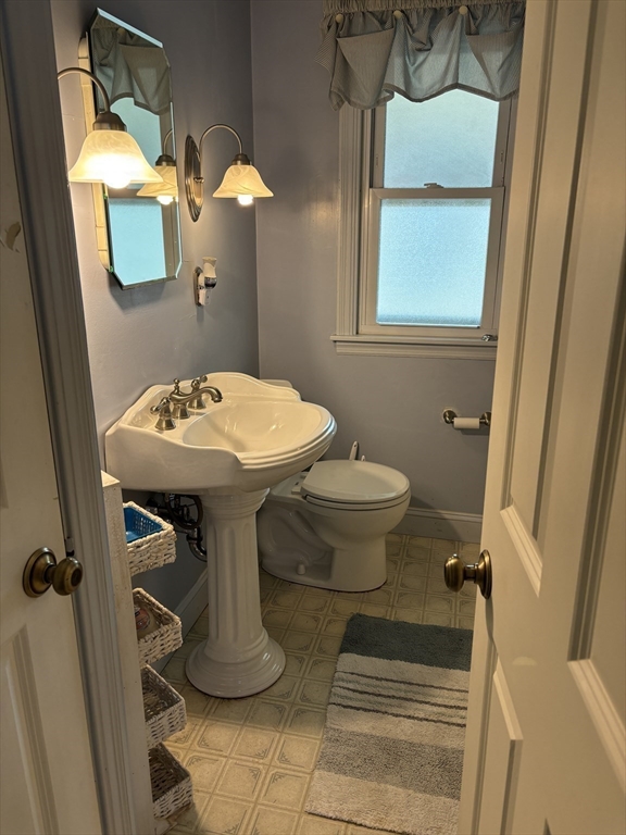 75 Powell Avenue Springfield, MA 01118 - Photo 11 of 25 a bathroom with a sink toilet and mirror