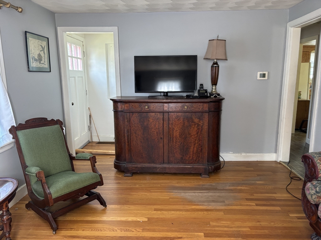 75 Powell Avenue Springfield, MA 01118 - Photo 12 of 25 a living room with furniture and a flat screen tv
