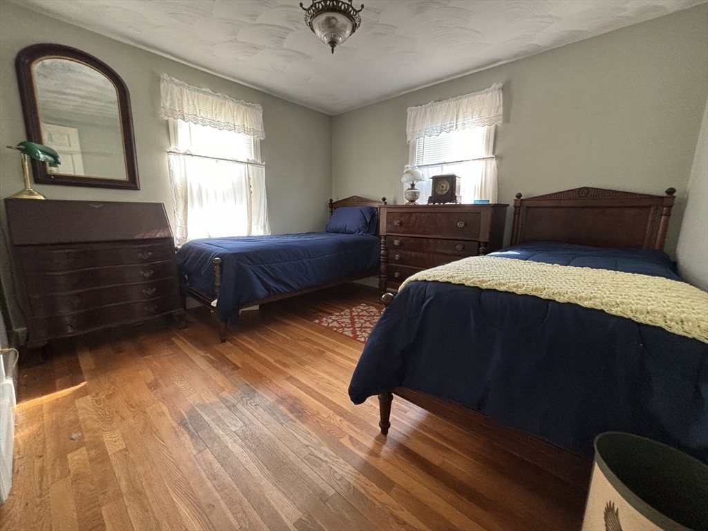 75 Powell Avenue Springfield, MA 01118 - Photo 17 of 25 a bedroom with a bed window and mirror