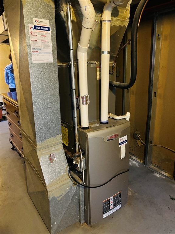 75 Powell Avenue Springfield, MA 01118 - Photo 24 of 25 a room with water heater and wooden cabinets