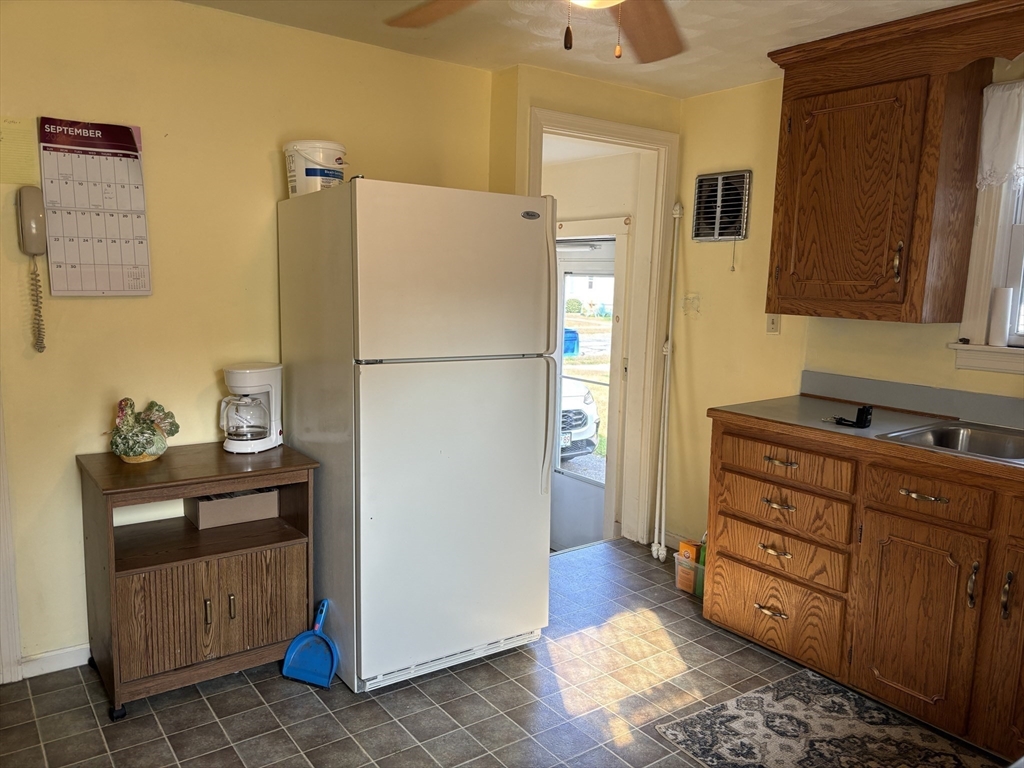 75 Powell Avenue Springfield, MA 01118 - Photo 4 of 25 a kitchen with stainless steel appliances granite countertop a refrigerator a stove and a sink with wooden floor