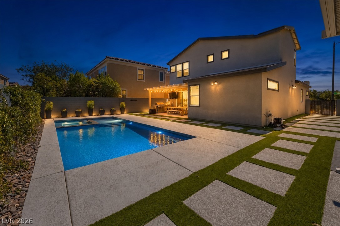 2166 Trivero Street Henderson, NV 89044 - Photo 54 of 61 Luminous pool and charming patio area create an inviting evening oasis.