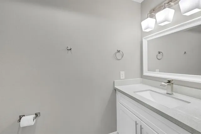 a bathroom with a sink vanity and a mirror