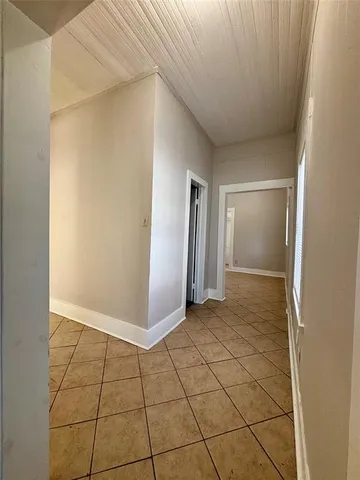 a view of a livingroom with an empty space and a window