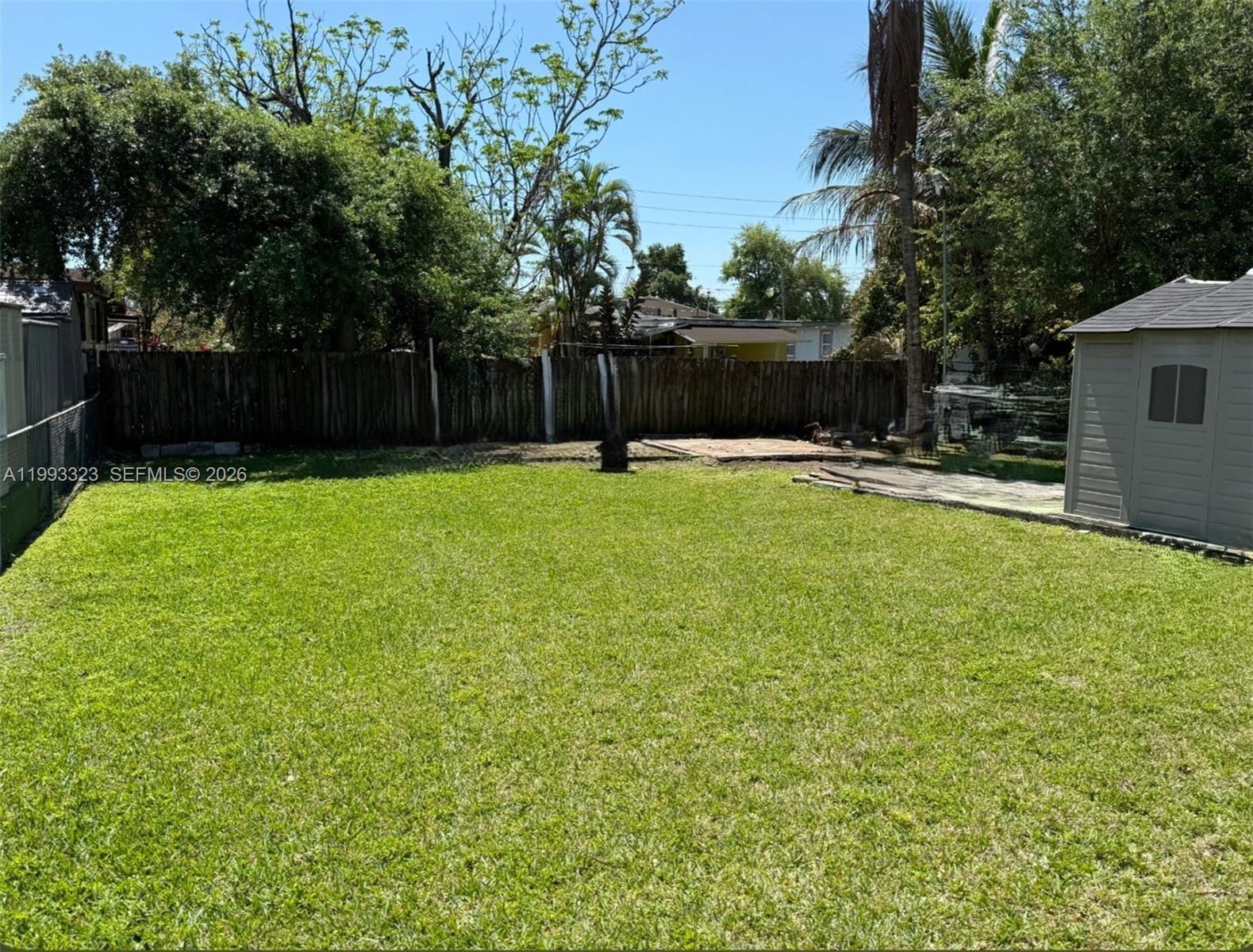 3066 Northwest 28th Street Miami, FL 33142 - Photo 4 of 6 a swimming pool with wooden fence
