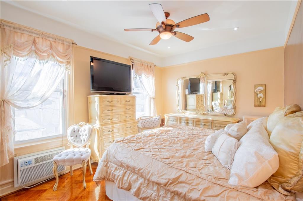 136 Bay Ridge Avenue Brooklyn, NY 11220 - Photo 13 of 48 a bedroom with a bed window and flat screen tv