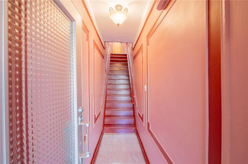136 Bay Ridge Avenue Brooklyn, NY 11220 - Photo 20 of 48 a view of a hallway with wooden floor and stairs