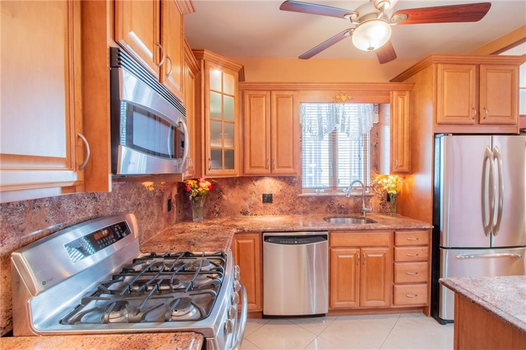 136 Bay Ridge Avenue Brooklyn, NY 11220 - Photo 2 of 48 a kitchen with a stove a sink and a refrigerator