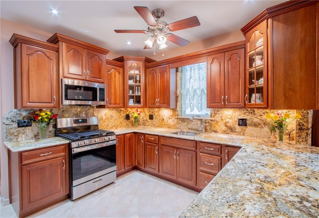 136 Bay Ridge Avenue Brooklyn, NY 11220 - Photo 24 of 48 a kitchen with stainless steel appliances granite countertop a stove sink microwave and refrigerator
