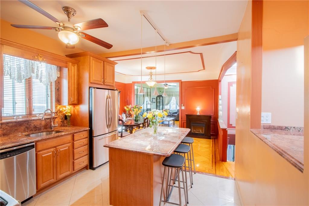 136 Bay Ridge Avenue Brooklyn, NY 11220 - Photo 3 of 48 a view of a kitchen with kitchen island a large window cabinets a sink and stainless steel appliances