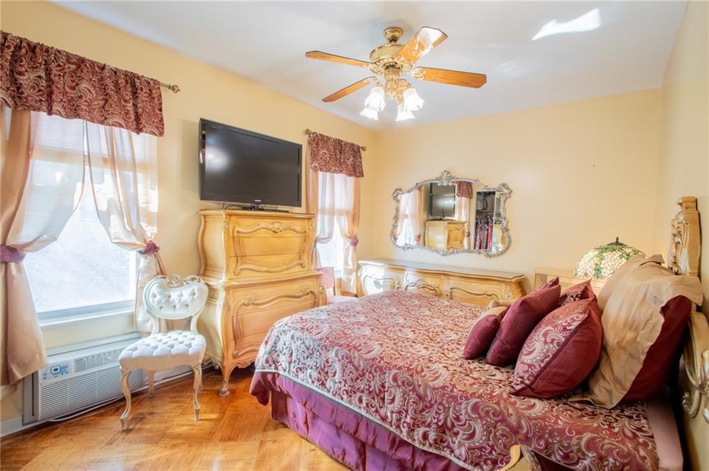 136 Bay Ridge Avenue Brooklyn, NY 11220 - Photo 31 of 48 a bedroom with a bed and a chandelier