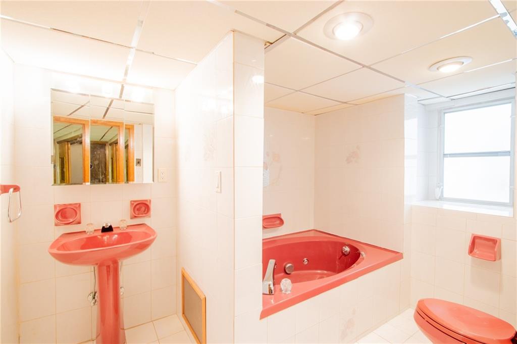 136 Bay Ridge Avenue Brooklyn, NY 11220 - Photo 35 of 48 a bathroom with a tub sink and mirror