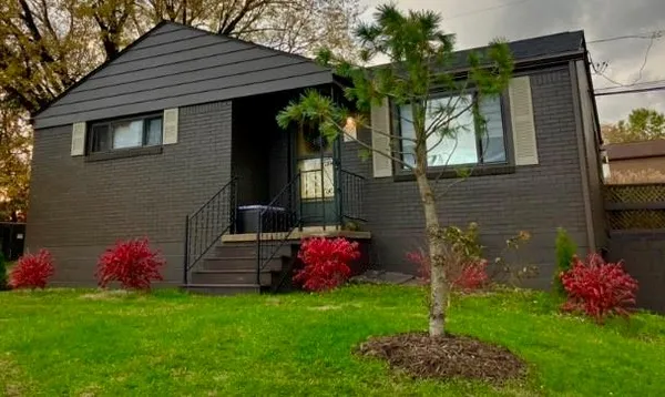 a front view of a house with garden