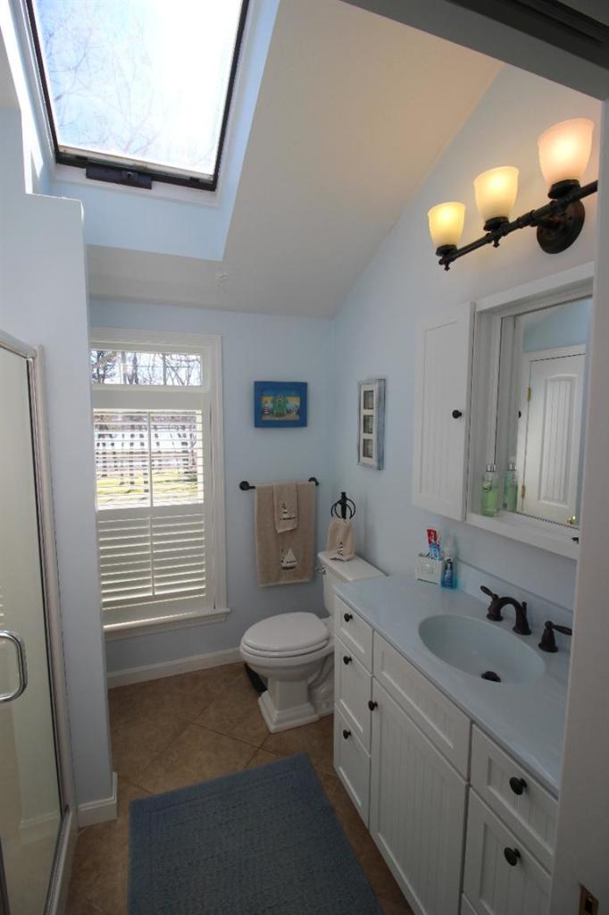 213 Monomoscoy Road Mashpee, MA 02649 - Photo 15 of 33 a bathroom with a sink a toilet and mirror
