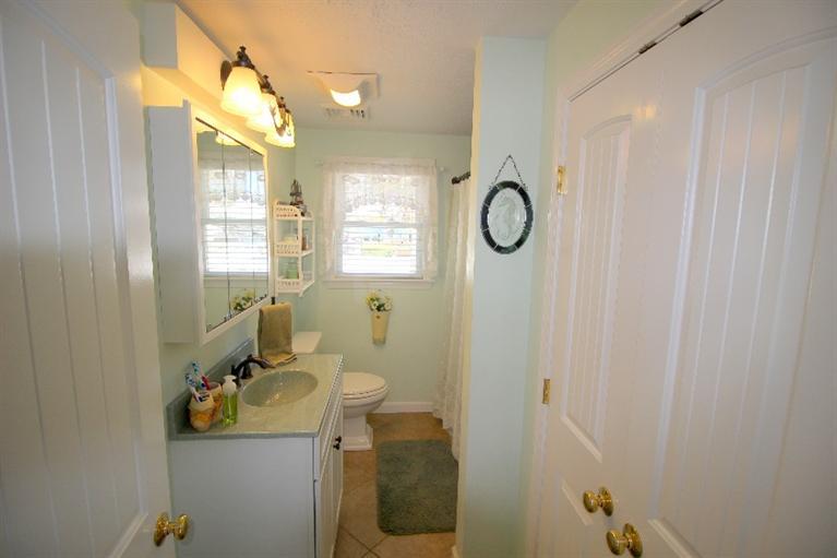 213 Monomoscoy Road Mashpee, MA 02649 - Photo 17 of 33 a bathroom with a sink mirror vanity and toilet