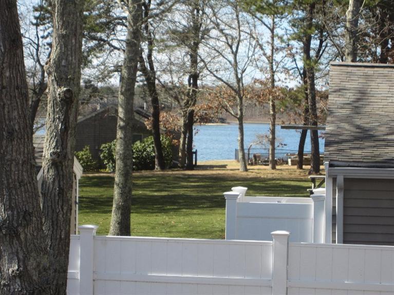 213 Monomoscoy Road Mashpee, MA 02649 - Photo 24 of 33 a view of a house with a yard and sitting area
