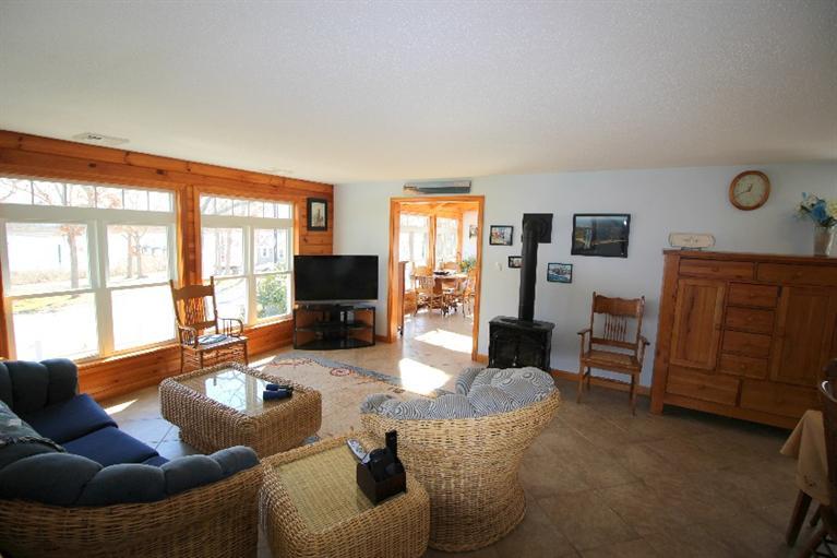213 Monomoscoy Road Mashpee, MA 02649 - Photo 7 of 33 a living room with furniture a flat screen tv and a large window