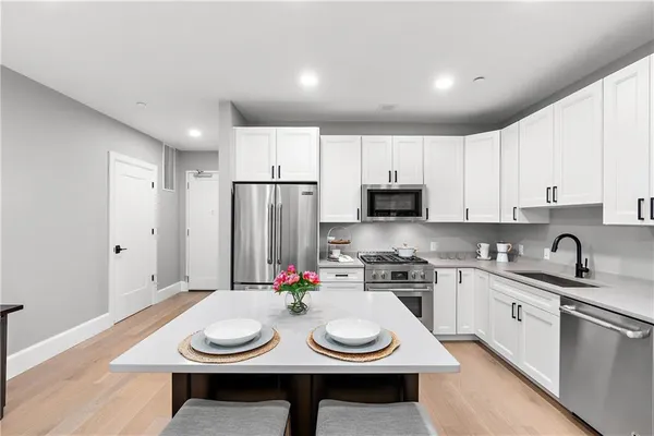 a kitchen with appliances a sink and cabinets
