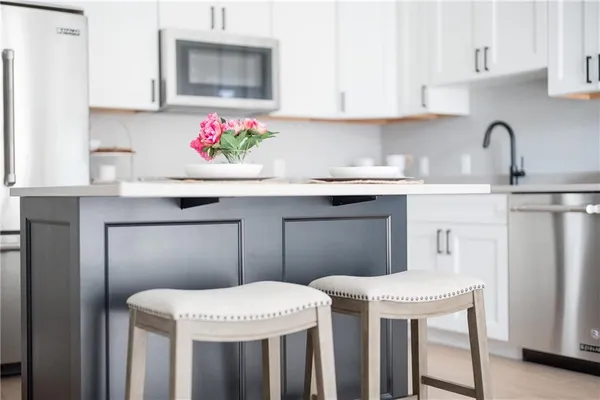 a kitchen with a sink a cabinets and window