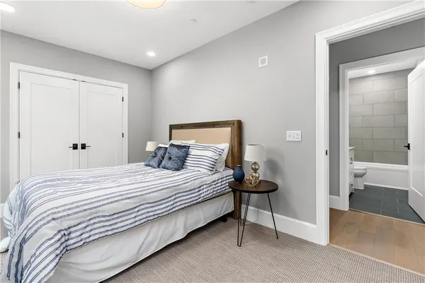 a bedroom with a bed and a night stand