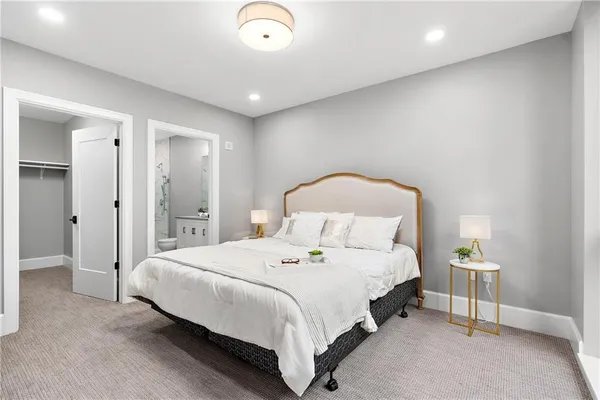 a bedroom with a bed and a lamp