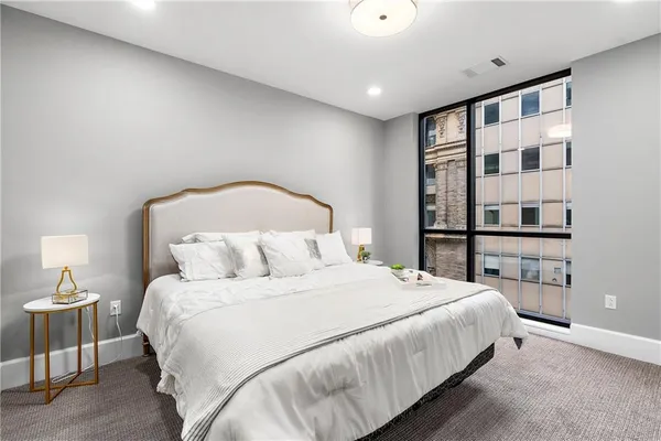 a bedroom with bed and a night stand